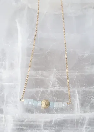 Delicate Bar Necklace Features Faceted Aquamarine Surrounded By a Gold Filled Sparkle Ball to Form a Curved Bar On Gold-Filled Chain Promote Calmness.
