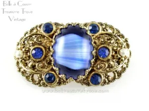 German Repousse Goldtone Brooch Variegated Blue Art Glass